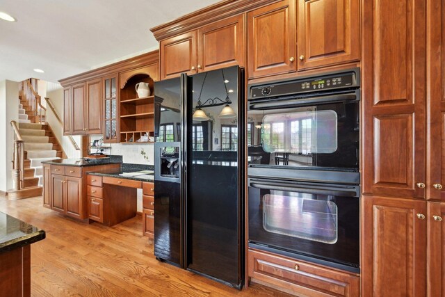 kitchen with black appliances, open shelves, light wood-type flooring, brown cabinets, and recessed lighting