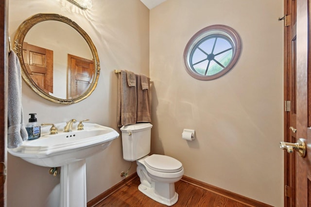 bathroom featuring wood finished floors, toilet, and baseboards