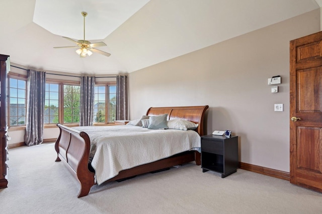 bedroom featuring light colored carpet, baseboards, a ceiling fan, and lofted ceiling