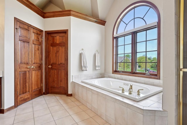bathroom with vaulted ceiling, a garden tub, and tile patterned flooring
