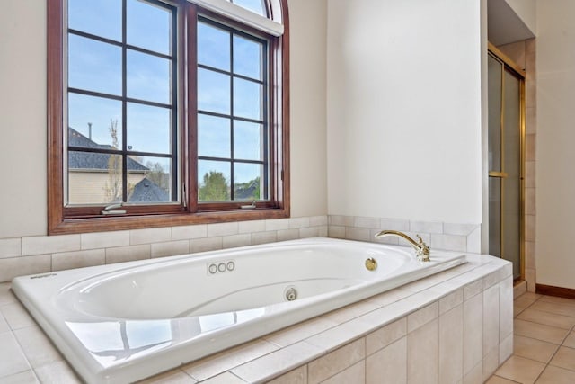 full bathroom featuring plenty of natural light, a shower stall, a bath, and tile patterned flooring