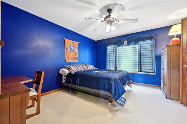 carpeted bedroom featuring baseboards and ceiling fan