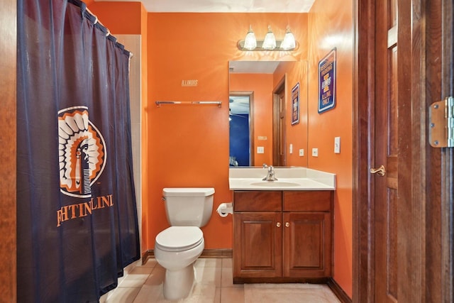 bathroom with tile patterned floors, toilet, vanity, and curtained shower