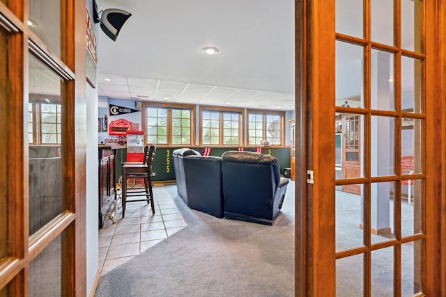carpeted living area with recessed lighting, french doors, and tile patterned flooring
