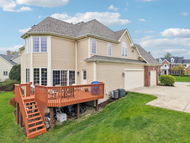 rear view of property featuring driveway, a yard, a deck, and cooling unit