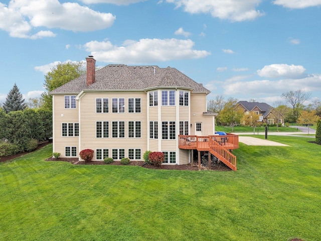 back of house with a chimney, a yard, and a wooden deck