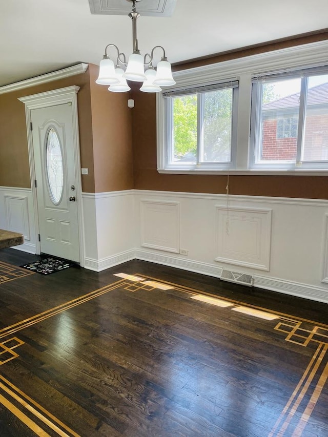 11362 S Laflin St, Chicago, IL 60643 - foyer entrance with dark wood finished floors, a wainscoted wall, a chandelier, and a decorative wall