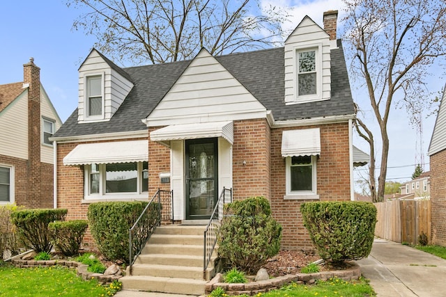 3666 176th Pl, Lansing, IL 60438 - cape cod-style house with fence, roof with shingles, a chimney, and brick siding