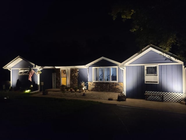 ranch-style home with board and batten siding and stone siding