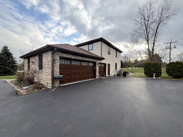 2 Rutgers Ct, Hawthorn Woods, IL 60047 - view of side of home featuring asphalt driveway, a garage, and brick siding