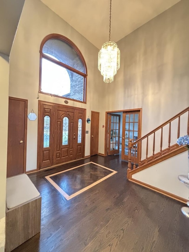 2 Rutgers Ct, Hawthorn Woods, IL 60047 - foyer featuring a towering ceiling, french doors, a chandelier, wood finished floors, and stairs