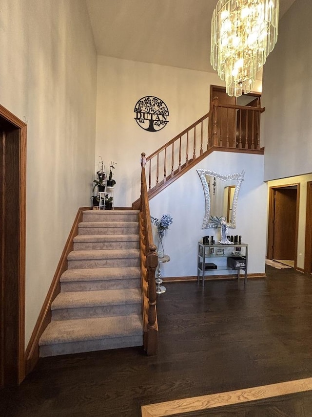 2 Rutgers Ct, Hawthorn Woods, IL 60047 - stairway with a chandelier, wood finished floors, a high ceiling, and baseboards