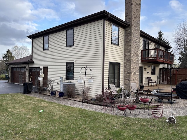 2 Rutgers Ct, Hawthorn Woods, IL 60047 - rear view of house featuring a chimney, driveway, a balcony, a yard, and a patio