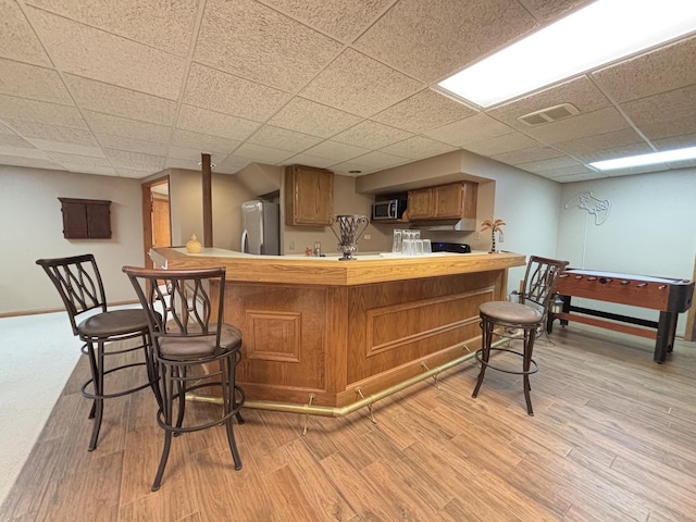 2 Rutgers Ct, Hawthorn Woods, IL 60047 - indoor wet bar with fridge, stainless steel microwave, light wood-style floors, baseboards, and a paneled ceiling