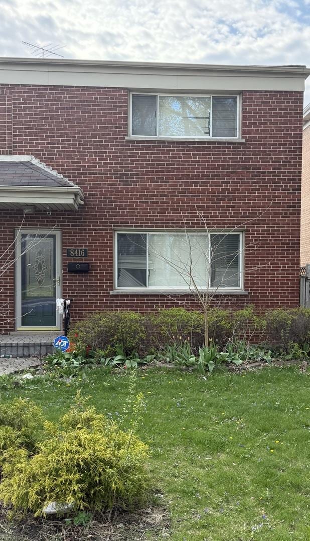 8416 Mccormick Blvd, Skokie, IL 60076 - view of property exterior with brick siding and a lawn
