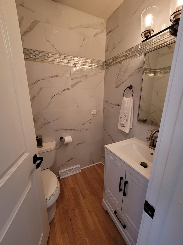8416 Mccormick Blvd, Skokie, IL 60076 - bathroom with vanity, toilet, wood finished floors, and visible vents