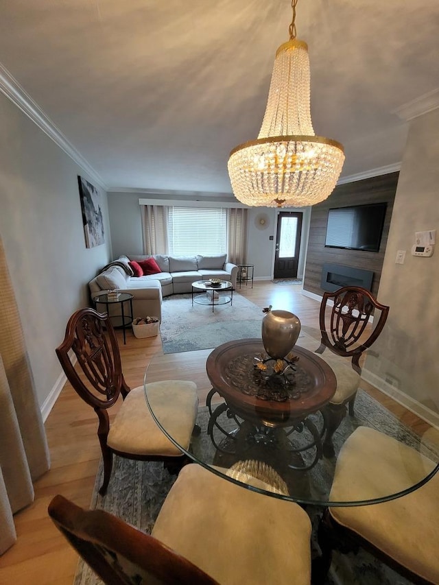 8416 Mccormick Blvd, Skokie, IL 60076 - dining space with baseboards, ornamental molding, wood finished floors, and a notable chandelier