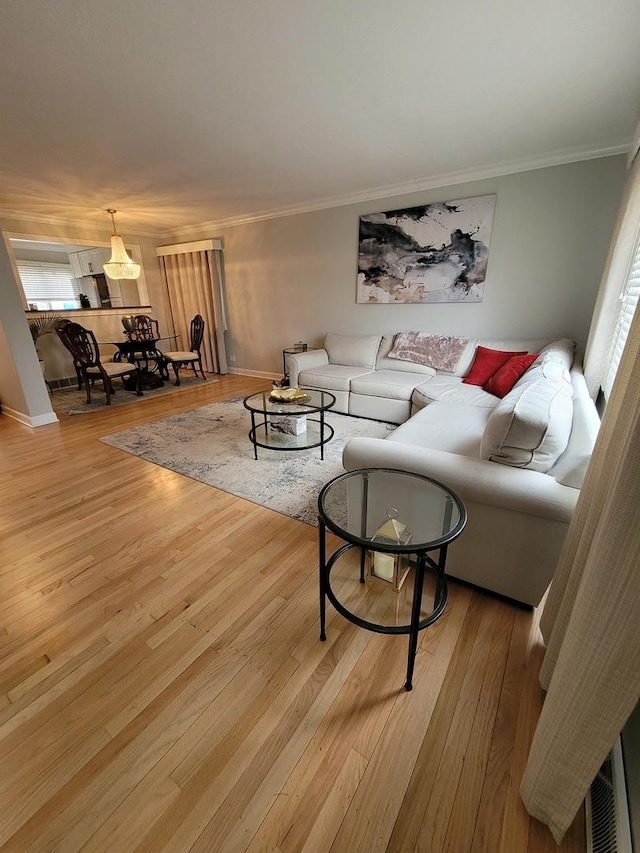 8416 Mccormick Blvd, Skokie, IL 60076 - living area featuring light wood-type flooring, baseboards, and crown molding
