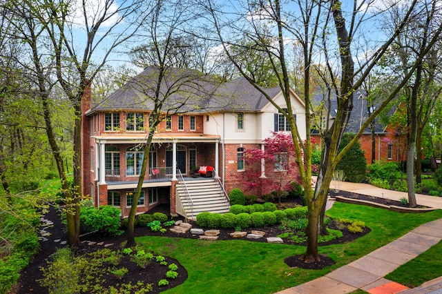 1303 Bonnema Ave, Naperville, IL 60565 - view of front of home featuring stairway, stucco siding, a front lawn, and brick siding