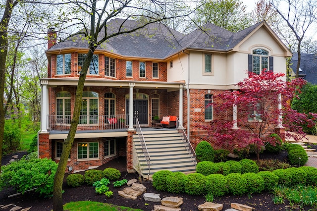 1303 Bonnema Ave, Naperville, IL 60565 - view of front of house with covered porch, stucco siding, stairway, and brick siding