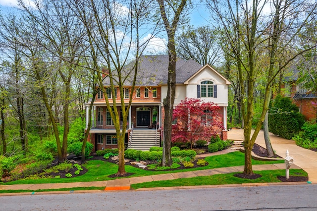 1303 Bonnema Ave, Naperville, IL 60565 - view of front of house with concrete driveway, stucco siding, covered porch, and stairs