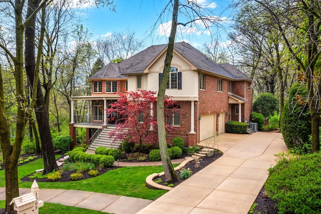 1303 Bonnema Ave, Naperville, IL 60565 - traditional home with brick siding, an attached garage, stucco siding, concrete driveway, and stairway