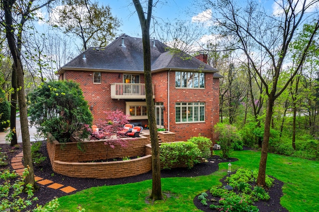1303 Bonnema Ave, Naperville, IL 60565 - back of property featuring a chimney, a balcony, a yard, brick siding, and a patio area