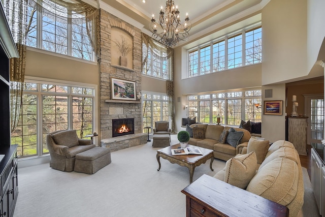 1303 Bonnema Ave, Naperville, IL 60565 - living area featuring carpet flooring, a high ceiling, a stone fireplace, a chandelier, and ornamental molding