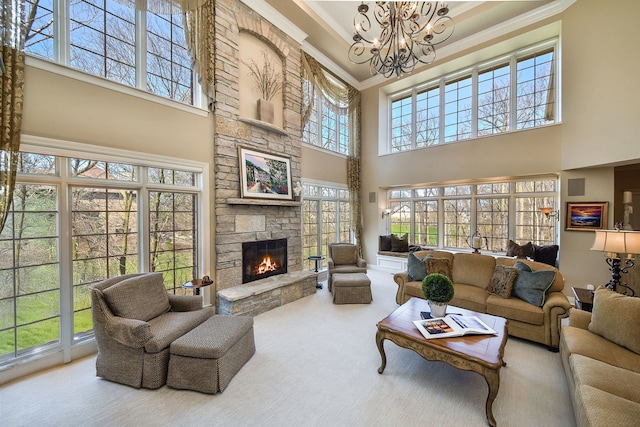 1303 Bonnema Ave, Naperville, IL 60565 - living area featuring a stone fireplace, a chandelier, crown molding, carpet floors, and a high ceiling