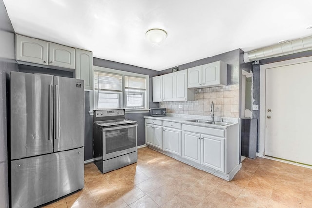 4026 N Kimball Ave, Chicago, IL 60618 - kitchen with light tile patterned floors, appliances with stainless steel finishes, light countertops, a sink, and decorative backsplash