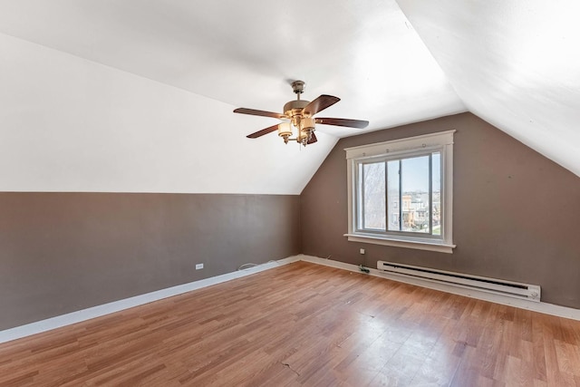4026 N Kimball Ave, Chicago, IL 60618 - additional living space featuring baseboards, vaulted ceiling, a baseboard heating unit, and wood finished floors