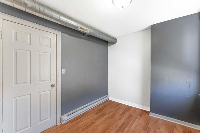4026 N Kimball Ave, Chicago, IL 60618 - basement with light wood-style floors, a baseboard heating unit, baseboards, and visible vents