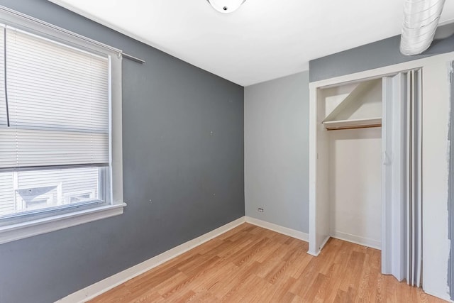 4026 N Kimball Ave, Chicago, IL 60618 - unfurnished bedroom with light wood-type flooring, a closet, and baseboards