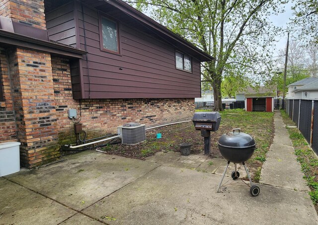18454 Ridgewood Ave, Lansing, IL 60438 - view of side of home featuring cooling unit, brick siding, fence, and a patio