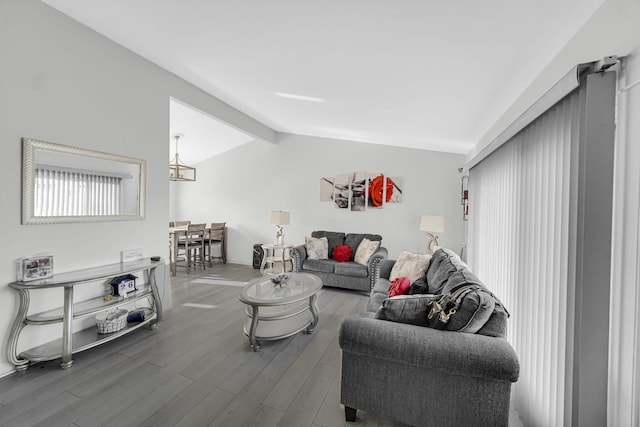 living area with wood finished floors and lofted ceiling with beams