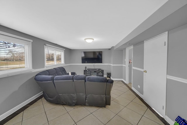living area featuring light tile patterned floors and baseboards