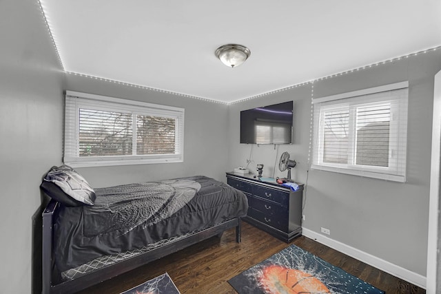bedroom featuring baseboards and wood finished floors