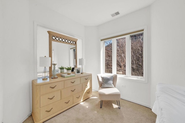 sitting room featuring light carpet, baseboards, and visible vents