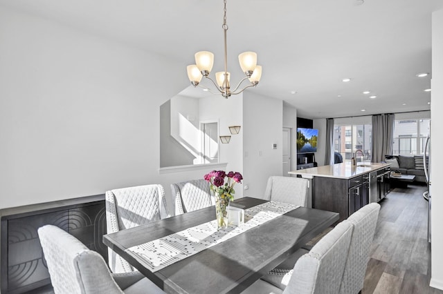dining room featuring dark wood-style flooring, recessed lighting, and a notable chandelier