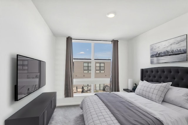bedroom featuring baseboards, multiple windows, and carpet floors