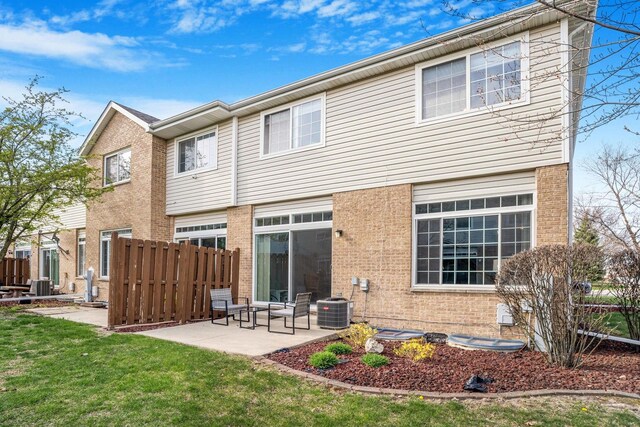 8411 Kirby Dr, Tinley Park, IL 60487 - rear view of property featuring cooling unit, a lawn, a patio, fence, and brick siding