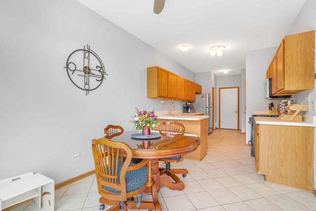 8411 Kirby Dr, Tinley Park, IL 60487 - kitchen with light tile patterned floors, a sink, light countertops, appliances with stainless steel finishes, and brown cabinets
