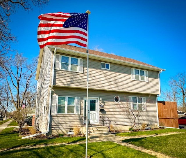 view of front of property featuring a front lawn and entry steps