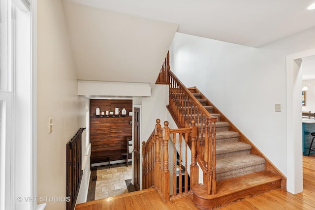 stairs featuring wood finished floors
