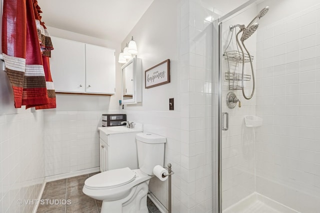 full bath with vanity, wainscoting, toilet, tile walls, and a shower stall