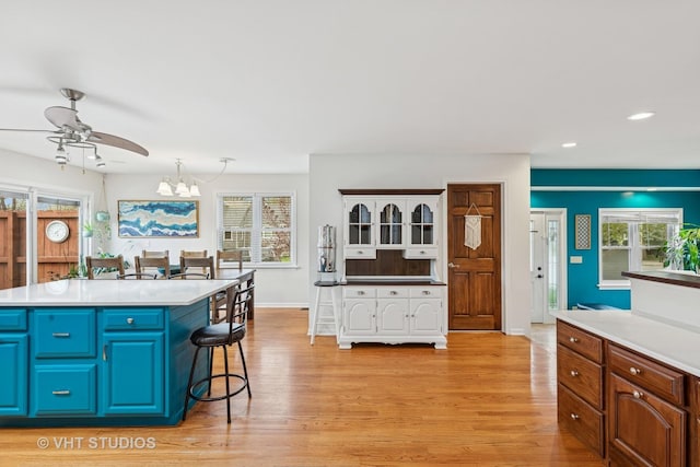 kitchen with a ceiling fan, blue cabinetry, recessed lighting, and light wood-style flooring
