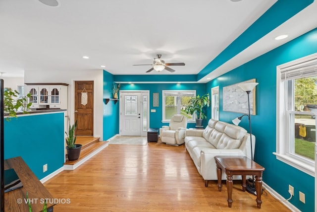living area featuring baseboards, recessed lighting, ceiling fan, and wood finished floors