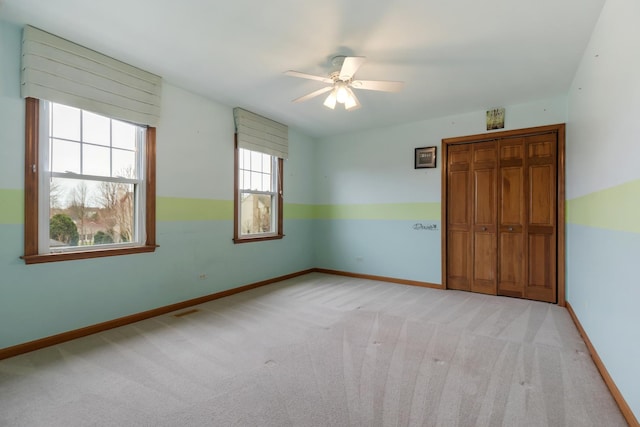 unfurnished bedroom with baseboards and light carpet