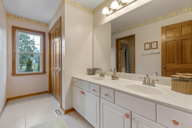 full bath featuring a sink, visible vents, baseboards, and tile patterned floors