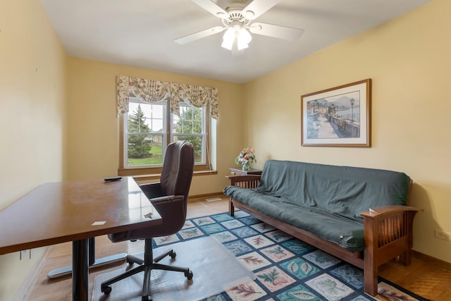 office area featuring baseboards and a ceiling fan
